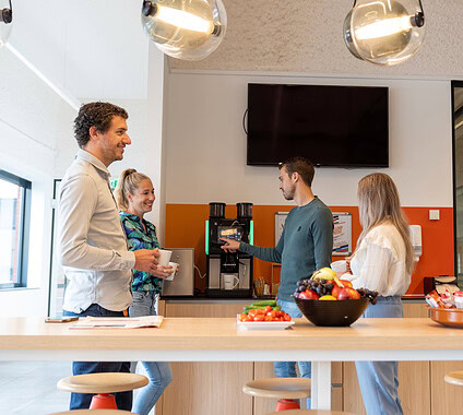 Enjoying coffee and snacks during a break at Keylane's vibrant office environment. Collaborative team atmosphere fostering innovation and growth in the insurance tech sector.