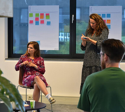 1. Diverse team participating in a Keylane Careers workshop, collaboration and innovation in a professional office environment with colorful sticky notes on whiteboards.