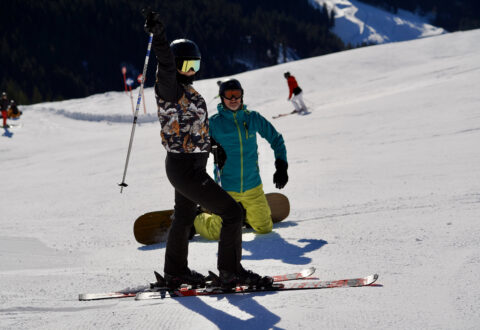 1. Skiers on snowy mountain slope with ski instructor, winter sports, skiing, snow adventure, mountain skiing, ski lesson, snowfall, outdoor winter activity, ski resort, high-altitude snow skiing.