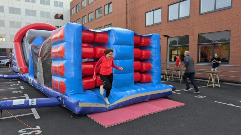 Jumping into fun at Keylane Careers inflatable bounce house for team building and employee engagement during corporate event.