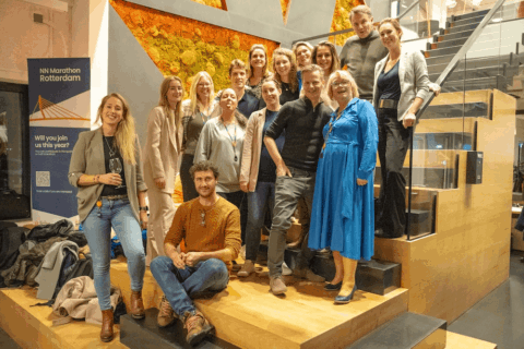 Diverse group of professionals smiling at Keylane Careers event in modern office space, promoting job opportunities, teamwork, and dynamic work environment.